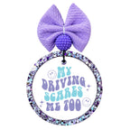 My Driving Scares Me Too retro purple and aqua typography with smiley faces and sparkles.