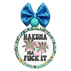 Hakuna ma fuck it text with palm trees and colorful background shapes.