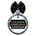I'm a school counselor not a magician text in colorful lettering on a black background.