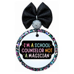 I'm a school counselor not a magician text in colorful lettering on a black background.