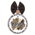Blessed text over neutral brush strokes with leopard-print accents.