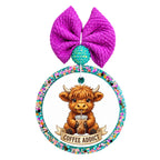 Cute Highland cow holding an iced coffee with Coffee Addict banner.