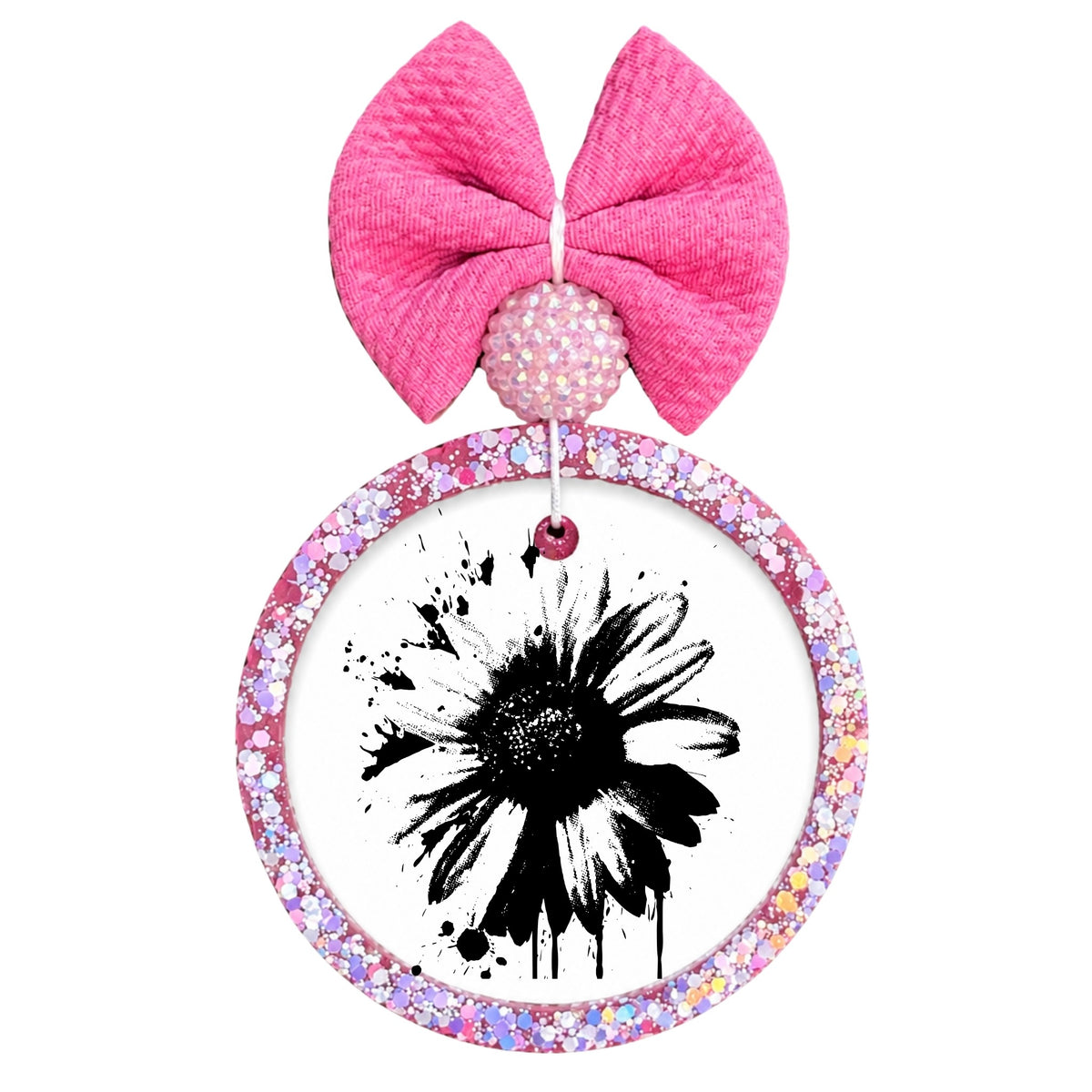 Black daisy silhouette with paint splatter accents.