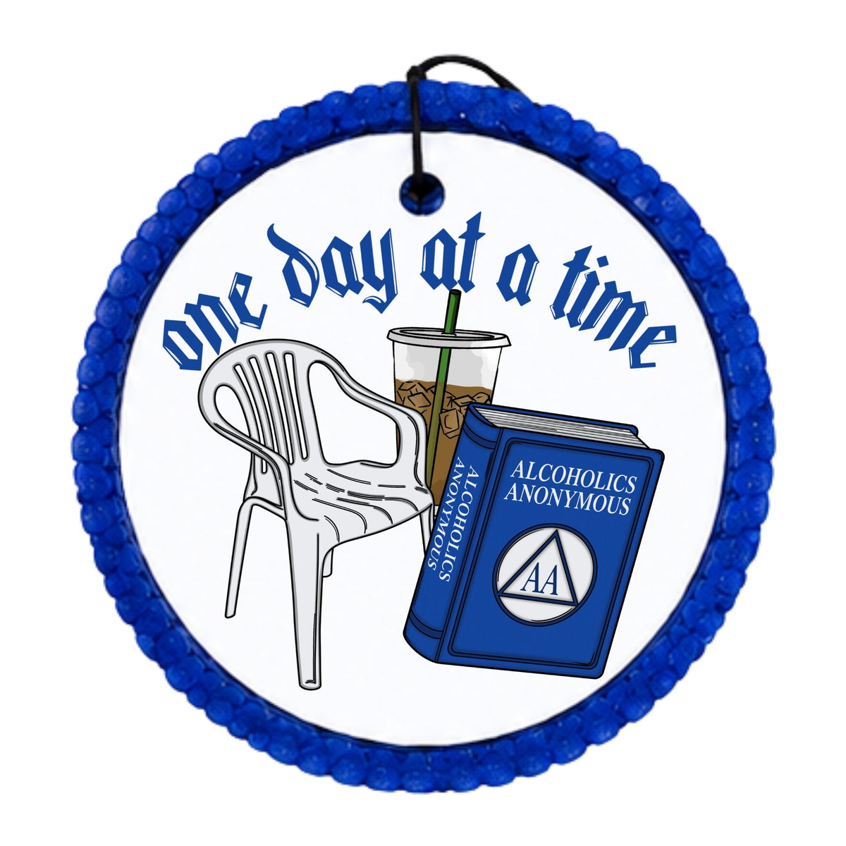 One Day at a Time text with an Alcoholics Anonymous book, AA symbol, chair, and iced drink.