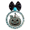 Western-style jack-o-lantern pumpkin decorated with turquoise stones and silver details.