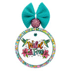 Wild & Free text with two hummingbirds, pink flowers, and star accents.