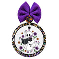 Ghost reading a celestial book while holding a black cat, surrounded by purple and orange flowers.