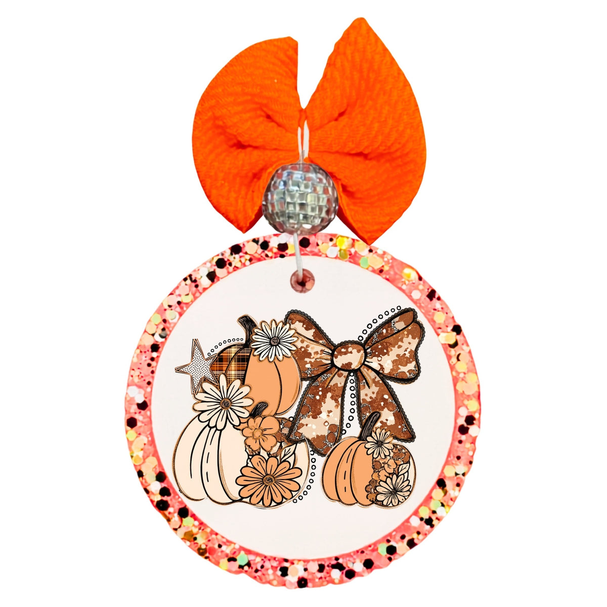 Fall pumpkin arrangement with cow-print bow, daisies, floral accents, and warm neutral colors.