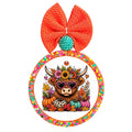 Highland cow wearing pink heart sunglasses surrounded by colorful fall flowers, leaves, and pumpkins.