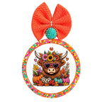 Highland cow wearing pink heart sunglasses surrounded by colorful fall flowers, leaves, and pumpkins.