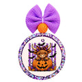 Halloween Highland cow sitting inside a jack-o-lantern with purple stripes, bats, stars, and fall accents.