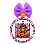 Halloween Highland cow sitting inside a jack-o-lantern with purple stripes, bats, stars, and fall accents.