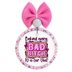 Bold pink and leopard quote saying Behind every bad bitch is a car seat.