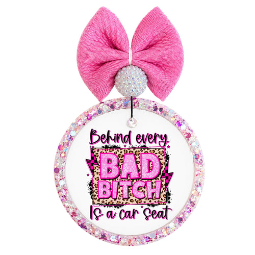 Bold pink and leopard quote saying Behind every bad bitch is a car seat.