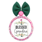 Blessed Grandma lettering framed by soft pink and white floral greenery.