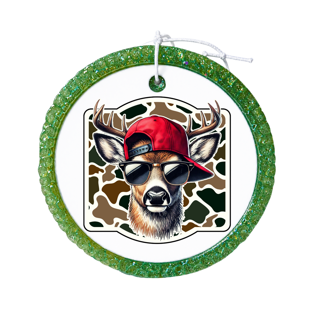 Deer wearing sunglasses and a red cap over a camouflage background.