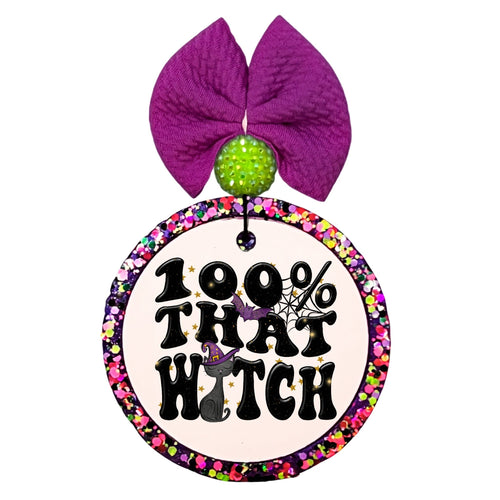 100% that witch in bold black lettering with a purple witch hat and small stars.
