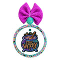 Stay witchy lettering on a colorful bubbling cauldron with a stirring spoon and stars.