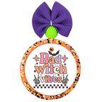 Bad witch vibes in pink and orange lettering with bats, stars, skeletal hands, and a black-and-white checkerboard.