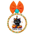 Pumpkin season lettering beneath a black kitten in a witch hat, surrounded by orange pumpkins and autumn leaves.