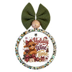 Holiday wine time lettering with a Highland cow, wine glass, red bows, and festive decorations.