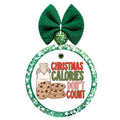 Christmas calories don't count in red and green lettering beside chocolate-chip cookies and a bottle of milk.