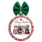 Meowy Christmas lettering above four cats dressed in festive winter clothes, with gold stars.