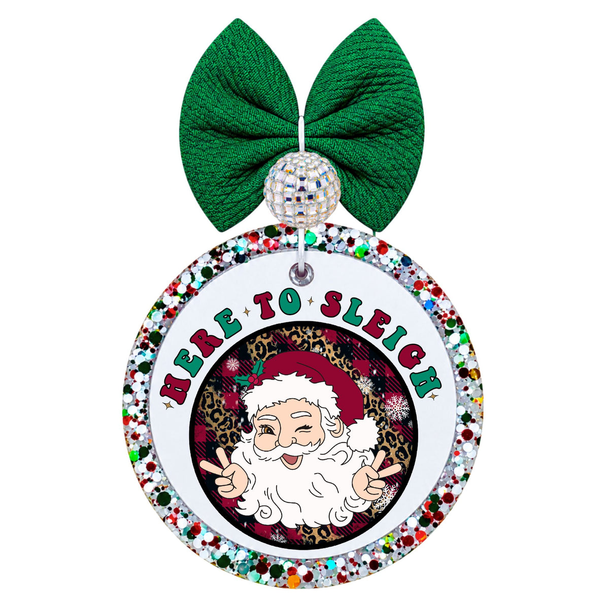Winking Santa making two peace signs against an ornate dark background with here to sleigh lettering.
