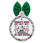 Three dancing Santas in pink and green with there’s some ho’s in this house lettering.