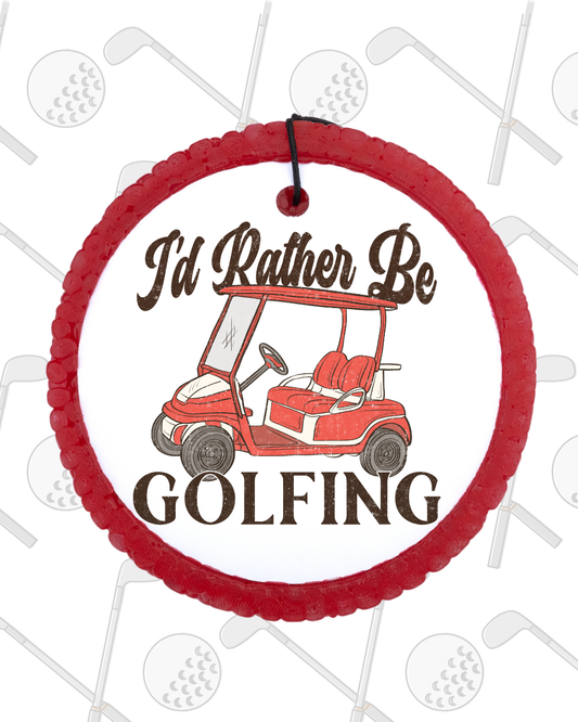 Circular red ornament with a golf cart graphic and 'I'd Rather Be Golfing' text on a white background with golf-themed decorations.
