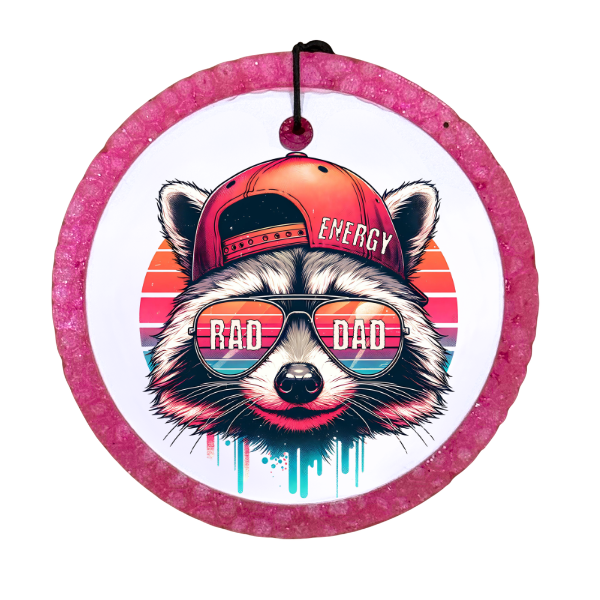 Illustration of a raccoon wearing sunglasses and a cap with 'Rad Dad' text, framed by a pink circle.