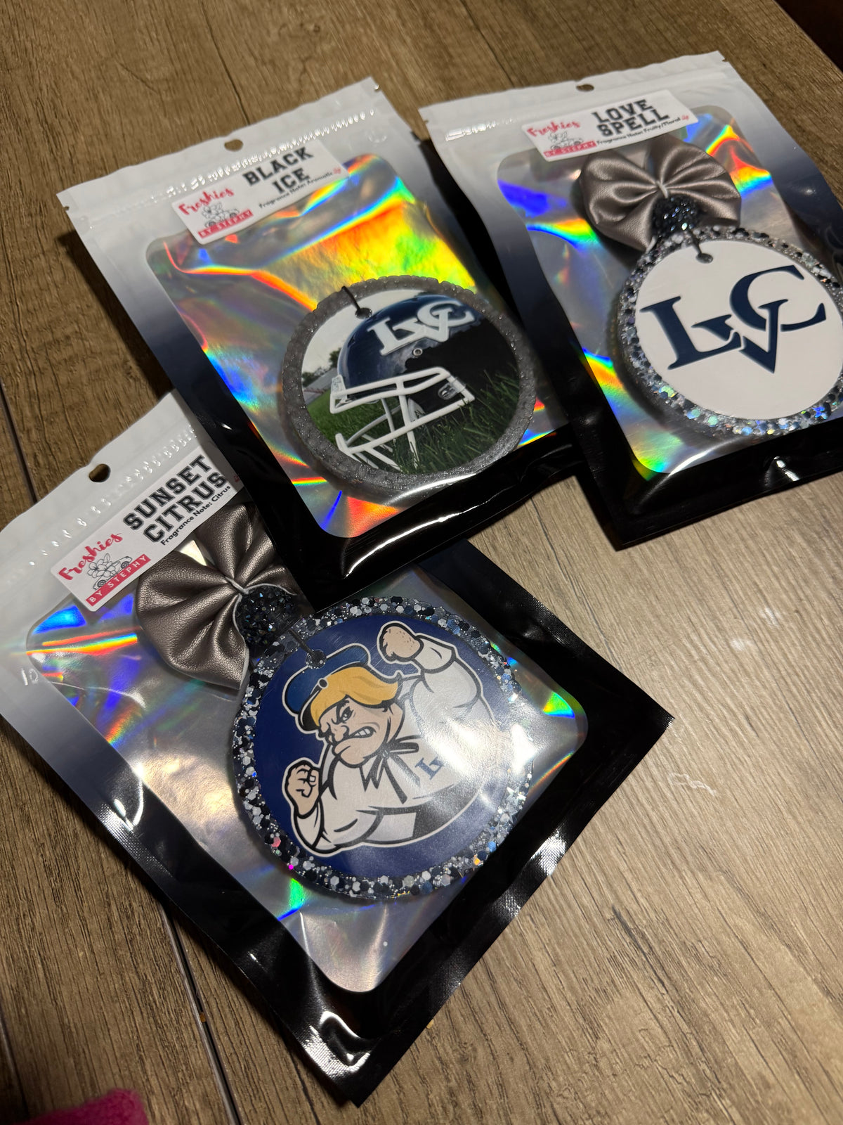3 hanging car fresheners with different school spirit designs for football team.