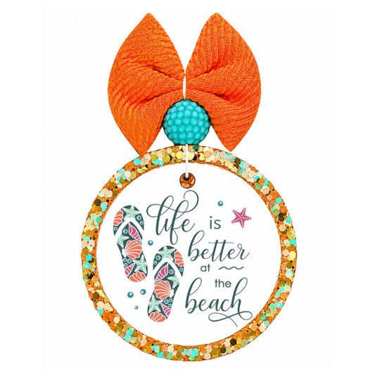 Decorative sign with orange bows and beach-themed text on a white background