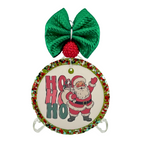 Ho Ho Ho in red and green block letters beside a standing Santa waving.